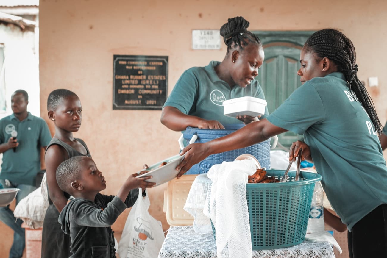 A field team distributes supplies together at a community centre in Ghana